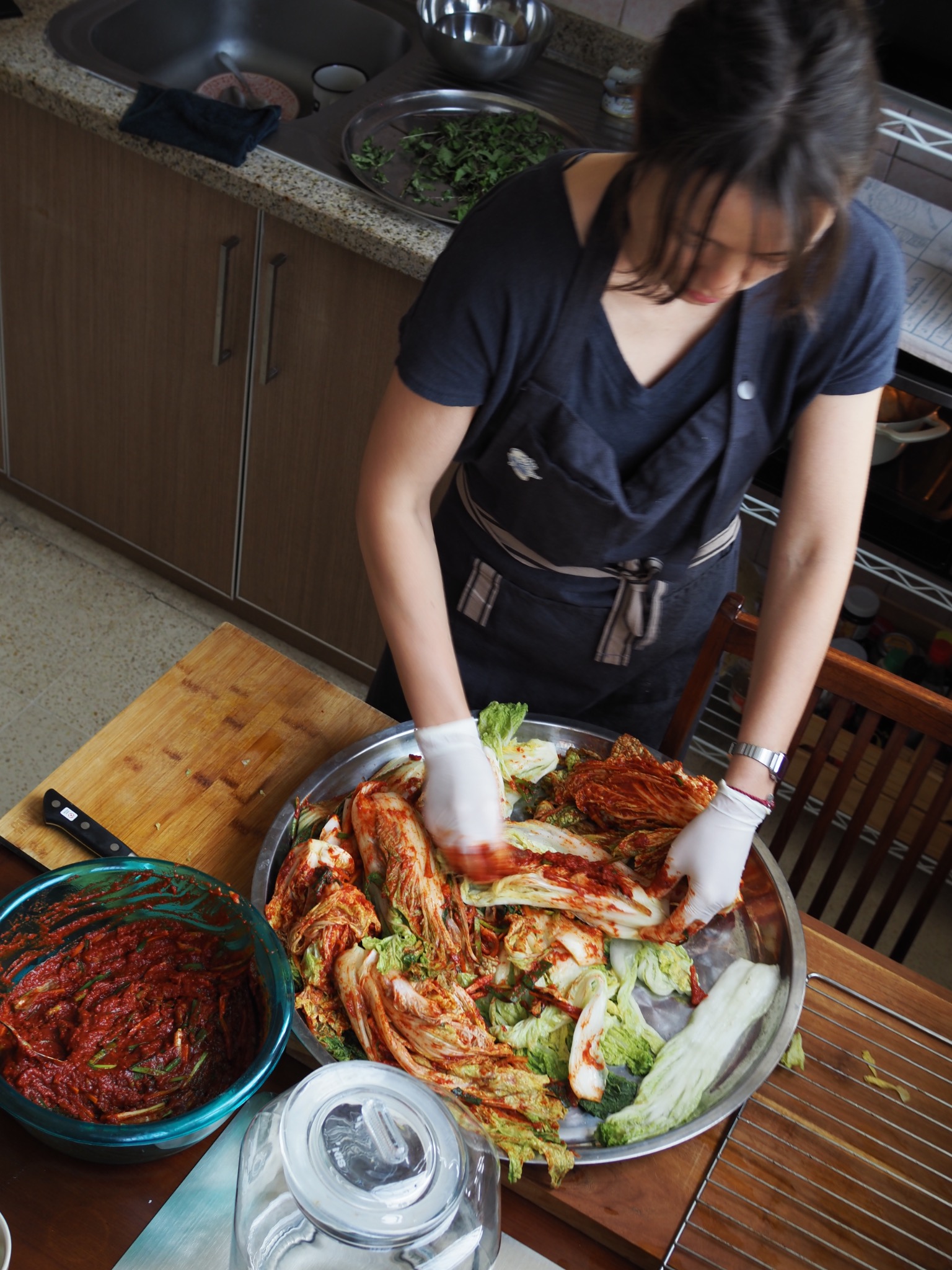 Vera making kimchi in her home kitchen